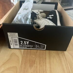 Boys UA cleats size 2.5